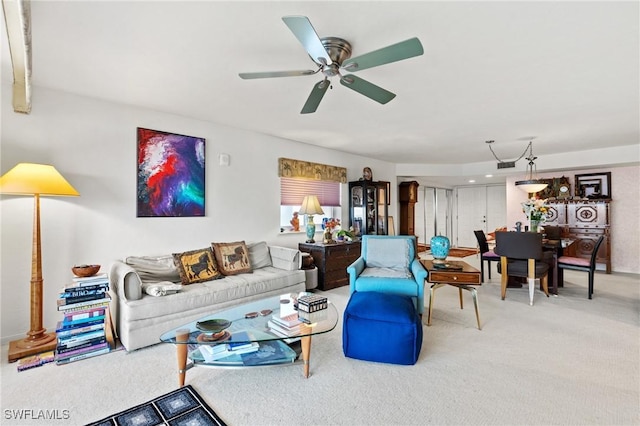 carpeted living room featuring ceiling fan