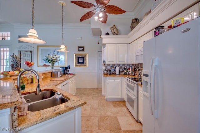 kitchen featuring white cabinets, white appliances, decorative light fixtures, and sink