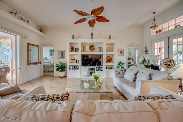 living room with ceiling fan and ornamental molding