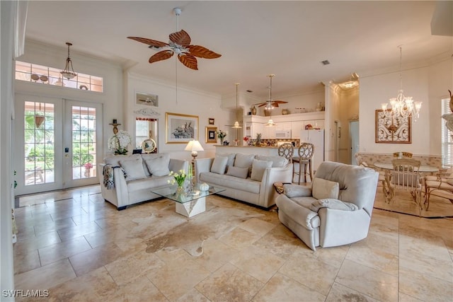 living room featuring ceiling fan with notable chandelier, ornamental molding, and french doors