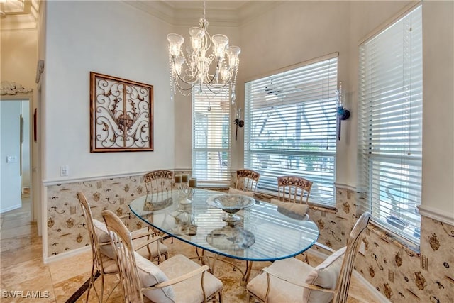 dining area with crown molding and a chandelier