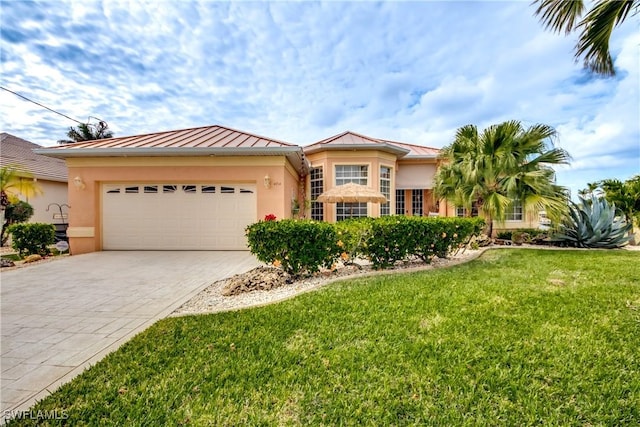 view of front of property with a front yard and a garage