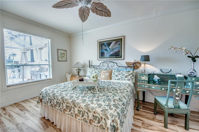 bedroom with ceiling fan, crown molding, and light wood-type flooring