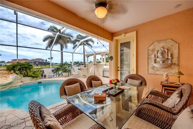 view of swimming pool featuring a patio and a lanai