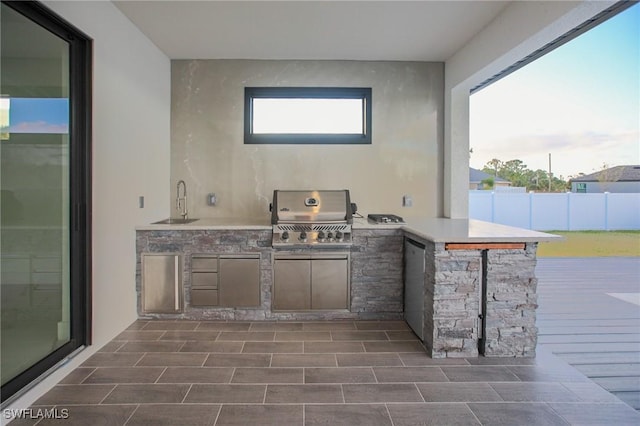 view of patio / terrace featuring area for grilling, an outdoor wet bar, and grilling area