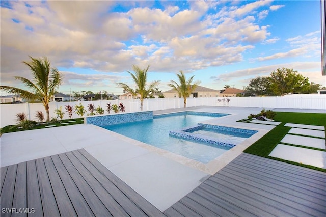 view of pool with a patio area and an in ground hot tub