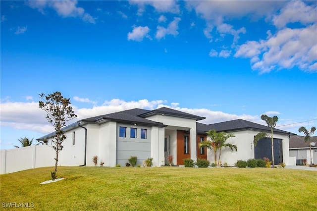 view of front of home with a garage and a front lawn