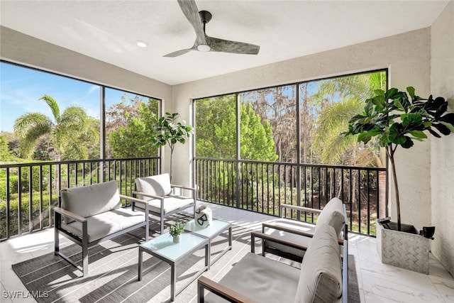 sunroom featuring ceiling fan