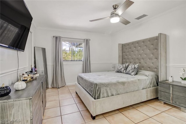 bedroom featuring ceiling fan, ornamental molding, and light tile patterned flooring