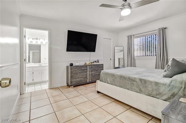 tiled bedroom featuring ceiling fan, crown molding, and connected bathroom