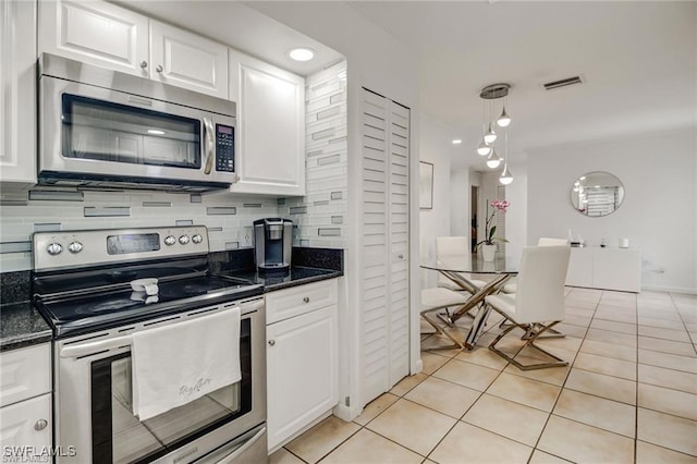 kitchen featuring white cabinetry, light tile patterned flooring, and appliances with stainless steel finishes