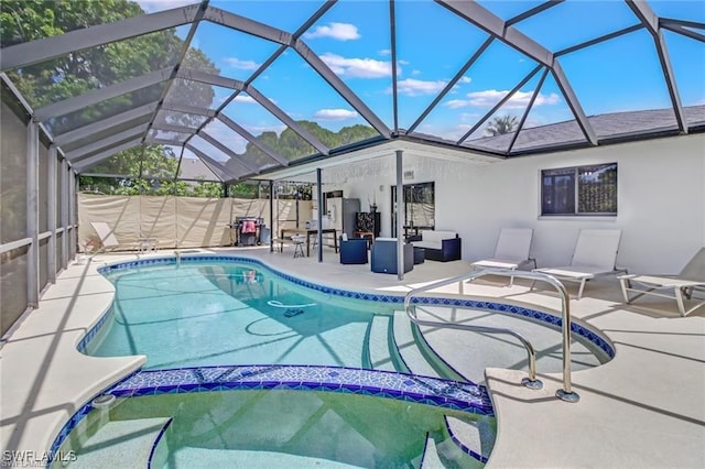 view of swimming pool featuring an outdoor hangout area, glass enclosure, and a patio area