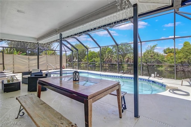 view of pool with a lanai, a patio area, a water view, and a jacuzzi