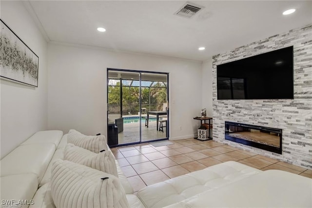 tiled living room featuring a stone fireplace and crown molding