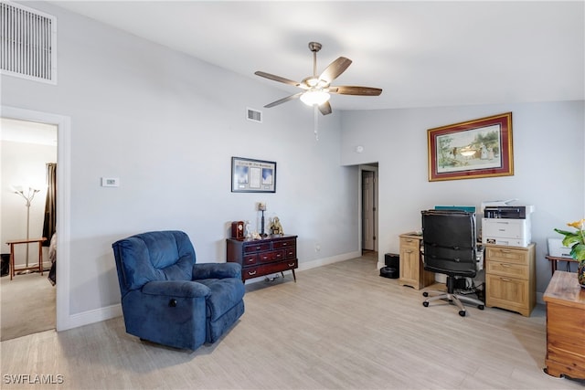 office with light wood-type flooring, high vaulted ceiling, and ceiling fan