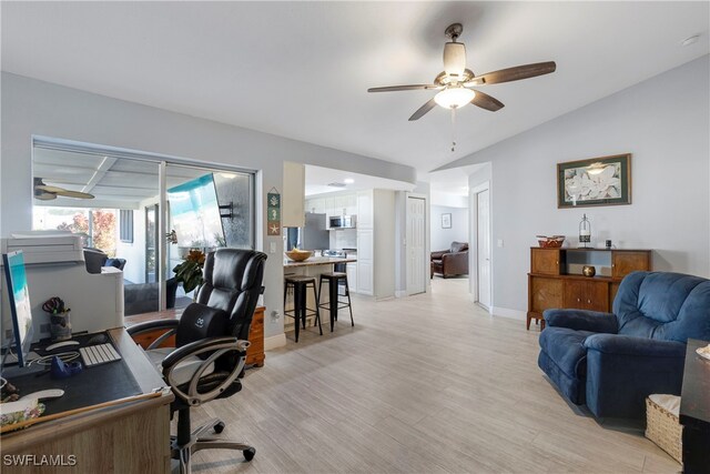 office area with ceiling fan, vaulted ceiling, and light hardwood / wood-style flooring