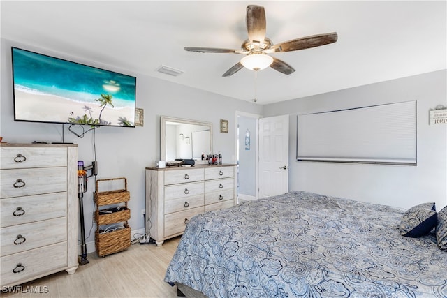 bedroom with ceiling fan and light hardwood / wood-style floors