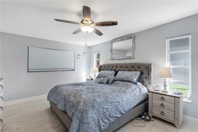 bedroom with ceiling fan and light wood-type flooring