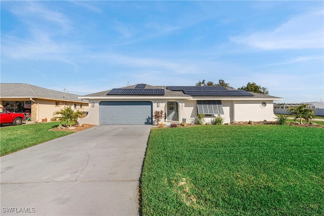 ranch-style house featuring solar panels, a garage, and a front yard