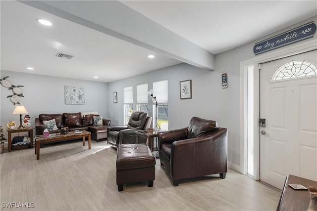 living room with beamed ceiling and light hardwood / wood-style floors