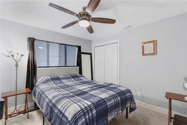 bedroom with ceiling fan, carpet floors, and a closet