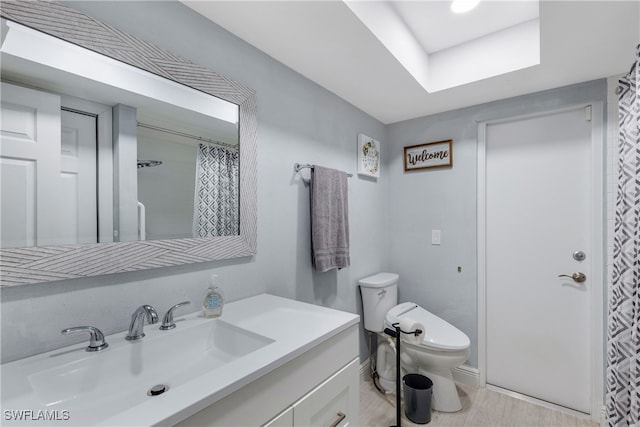 bathroom featuring vanity, toilet, and walk in shower