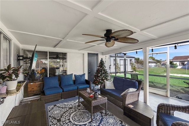 sunroom / solarium featuring beam ceiling, coffered ceiling, and a ceiling fan