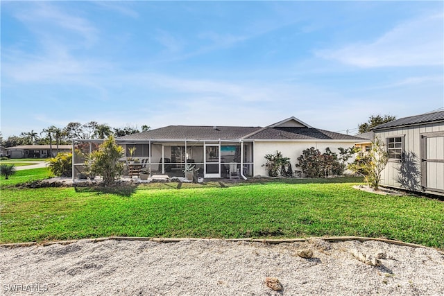 back of house featuring a lanai, stucco siding, a yard, and a storage unit