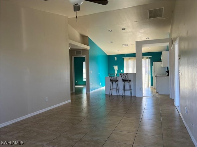 kitchen with white cabinetry, ceiling fan, tile patterned flooring, high vaulted ceiling, and white refrigerator