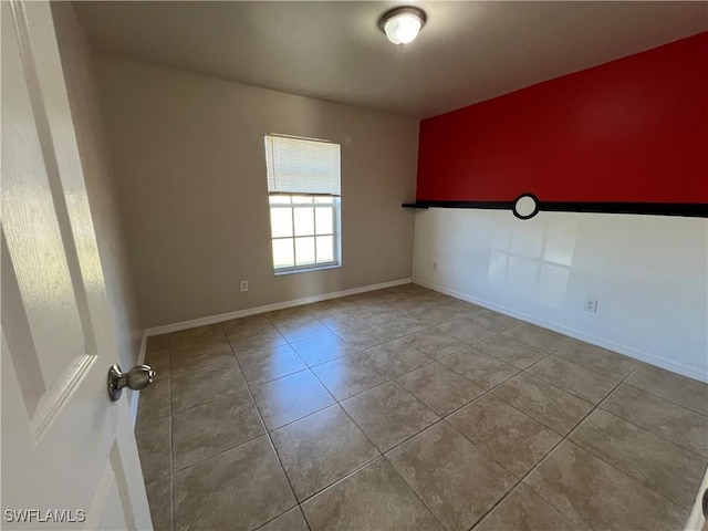 spare room featuring light tile patterned flooring