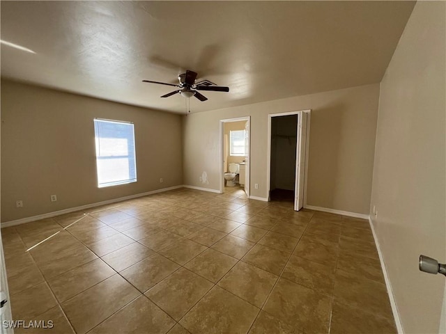 spare room featuring tile patterned floors and ceiling fan