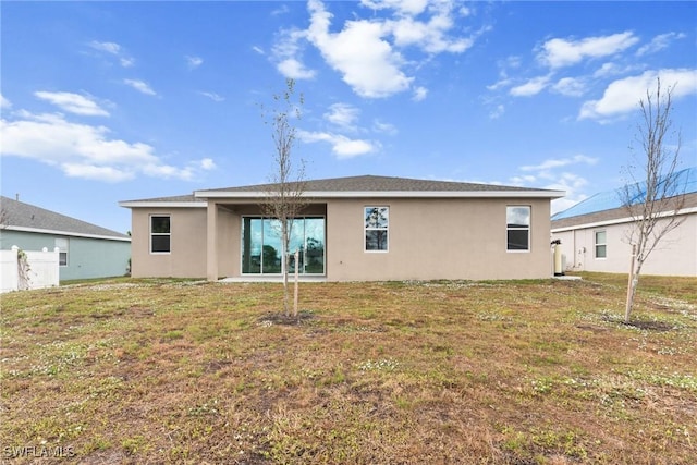 rear view of property with a yard