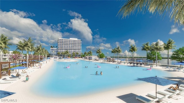 view of swimming pool with a water view and a view of the beach