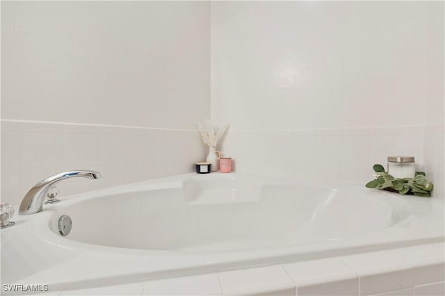 bathroom with tiled bath