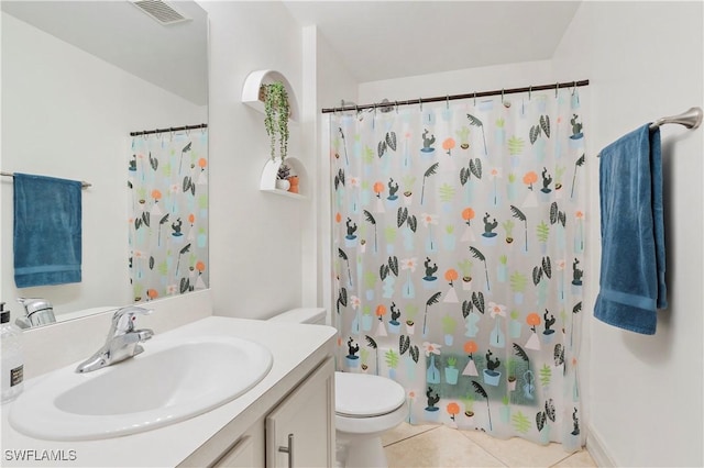 bathroom featuring tile patterned floors, toilet, and vanity