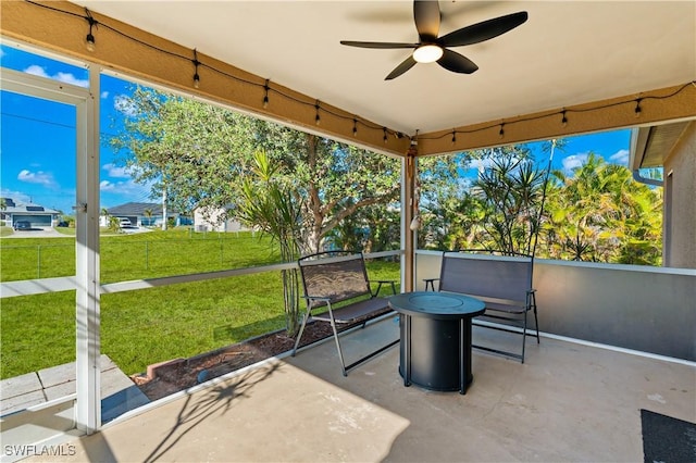 unfurnished sunroom featuring ceiling fan