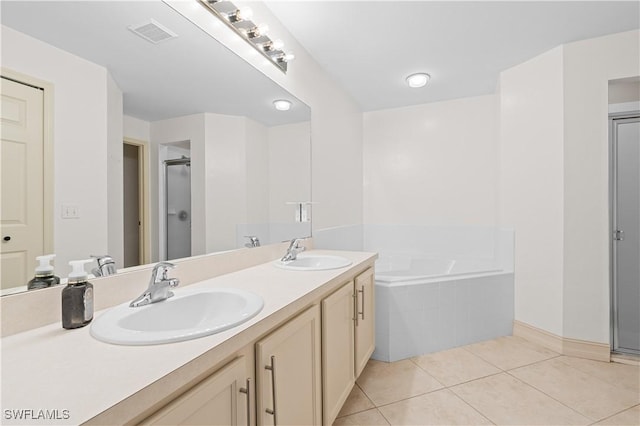 bathroom with tile patterned flooring, vanity, and separate shower and tub