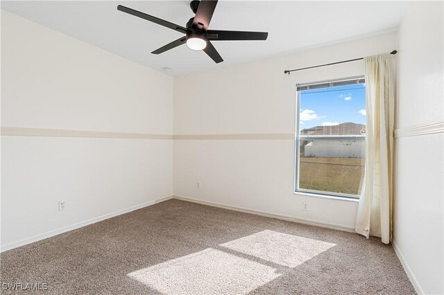 carpeted empty room featuring ceiling fan