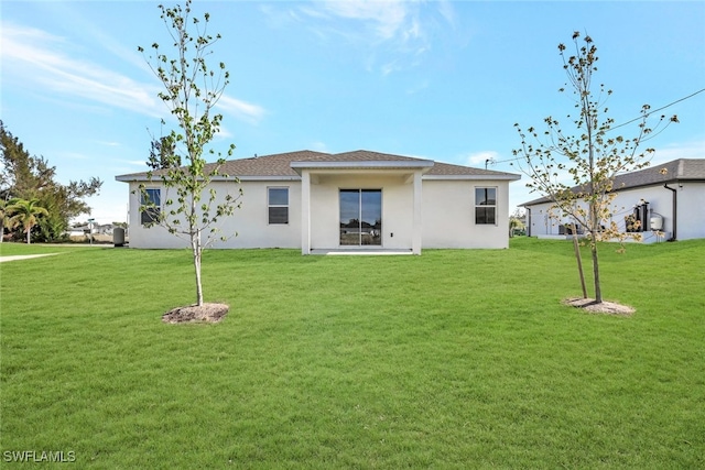 rear view of property with a yard