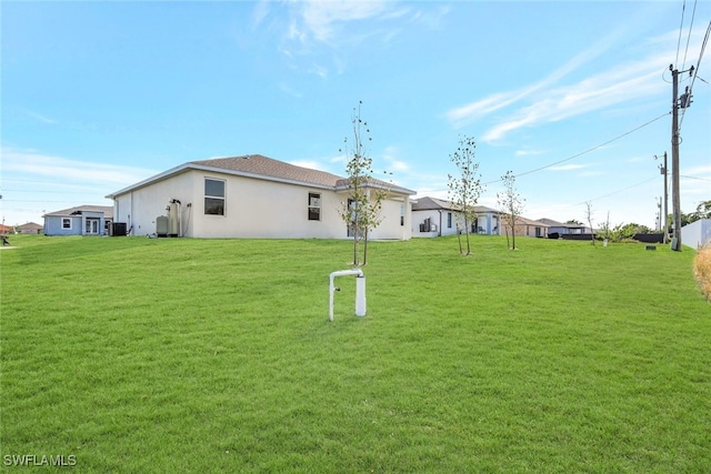 rear view of house with a yard