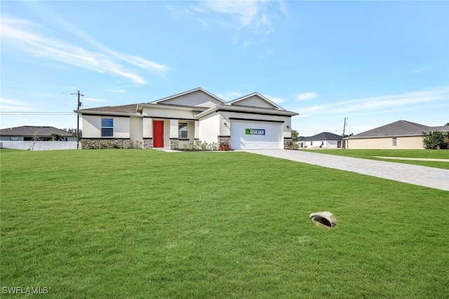 view of front of house with a front yard and a garage