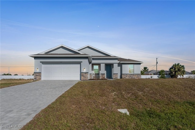 view of front of house with a garage and a yard