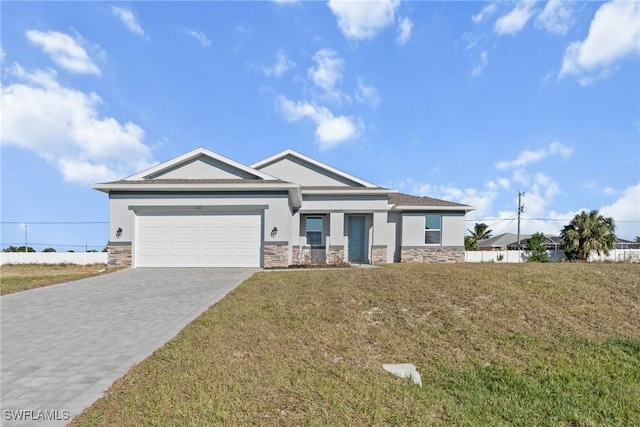 view of front of home with a front yard and a garage