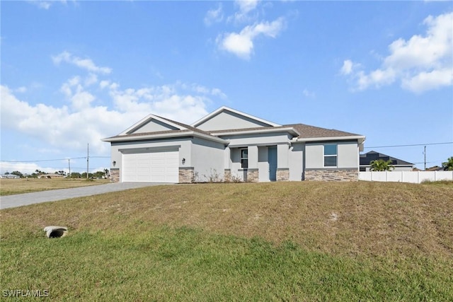 view of front of property with a garage and a front lawn