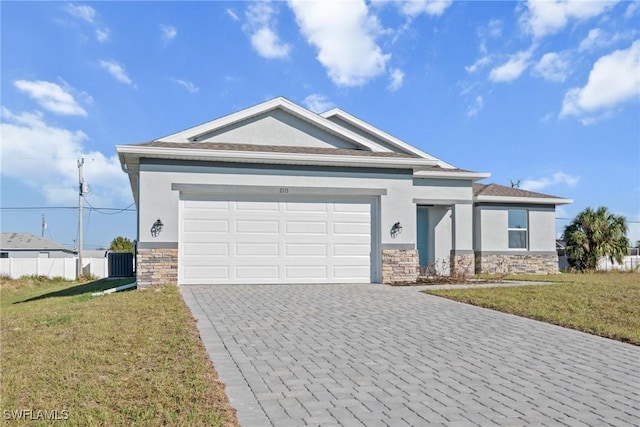 view of front of property with a front yard and a garage