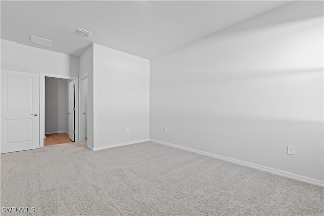 unfurnished room featuring light colored carpet