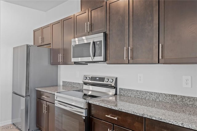 kitchen featuring light stone countertops, appliances with stainless steel finishes, and dark brown cabinets