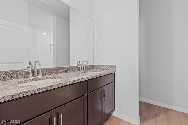 bathroom featuring hardwood / wood-style flooring and vanity