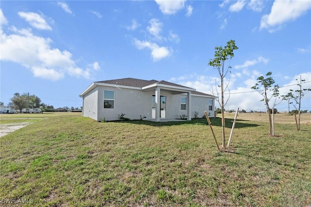 back of house with a lawn