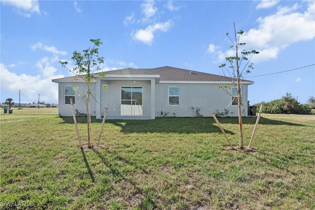 back of property featuring a lawn